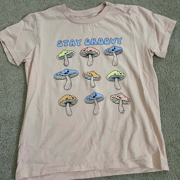 Grayson Threads Tops - Super cute graphic tee, “Stay Groovy” in a peach color with mushrooms under